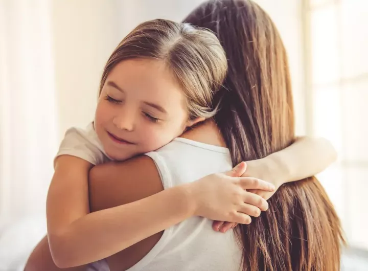 daughter hugs mother tightly